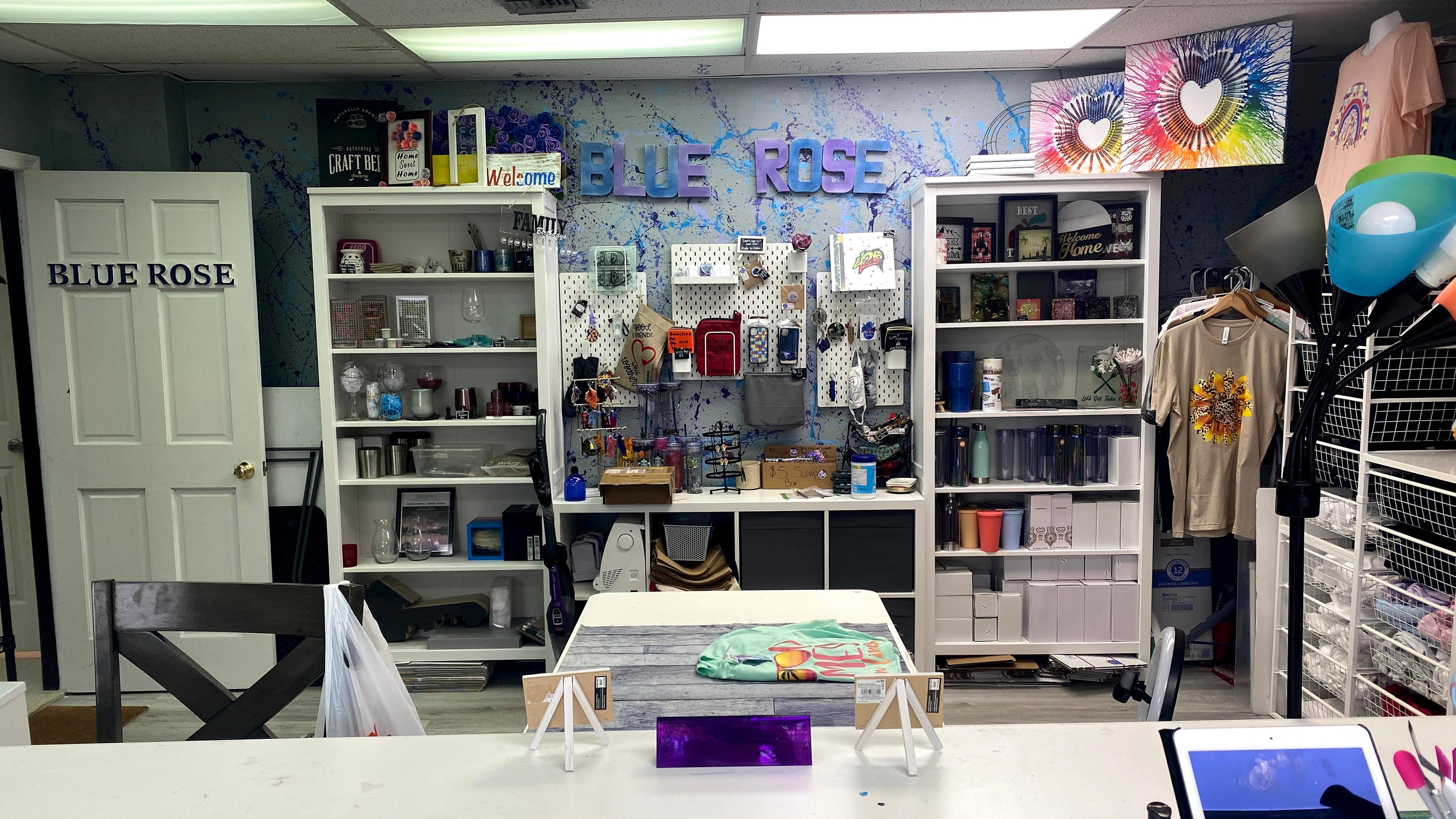 A picture of blue roses first store from 2021. There are shelves displayed items for sale.